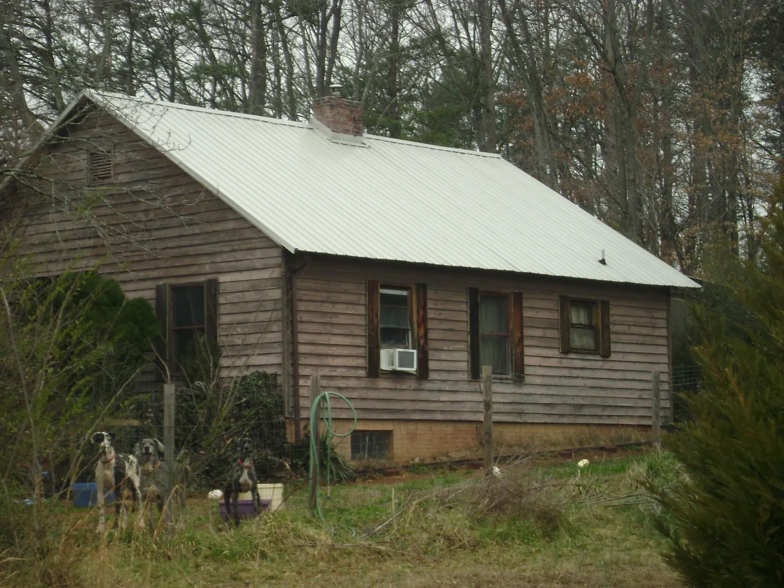 White metal roof on an old wood sided farmhouse, from a Metal Roof Installation job in Olivehill