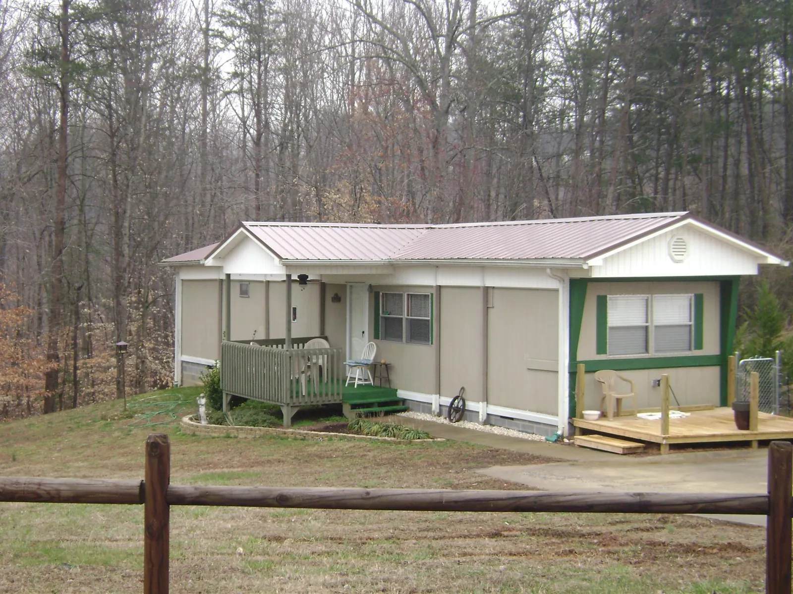 Mauve metal roof on a manufactured home with a new front deck in Olivehill